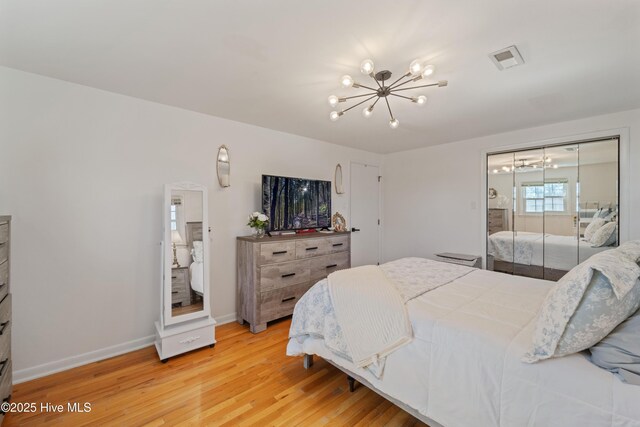 722 Christine Ave, Jacksonville, NC 28540 - bedroom featuring a closet, a chandelier, light wood finished floors, baseboards, and visible vents