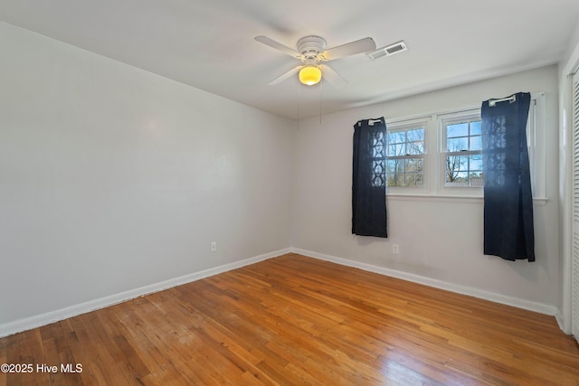 722 Christine Ave, Jacksonville, NC 28540 - spare room with baseboards, ceiling fan, visible vents, and hardwood / wood-style flooring