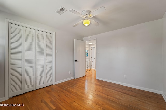 722 Christine Ave, Jacksonville, NC 28540 - unfurnished bedroom with a closet, wood finished floors, baseboards, visible vents, and ceiling fan