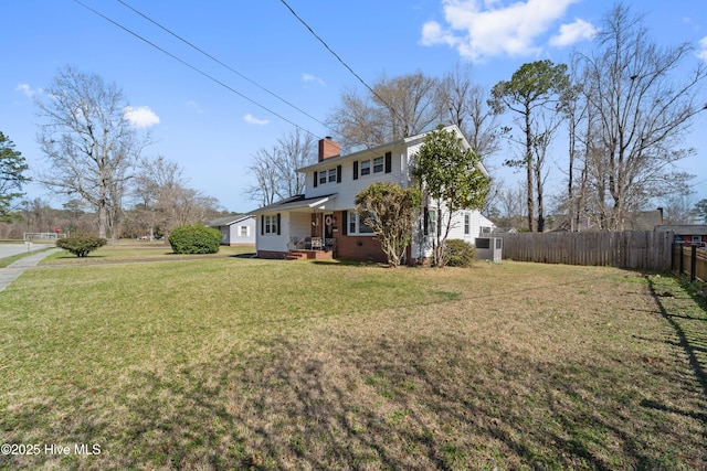 722 Christine Ave, Jacksonville, NC 28540 - view of front of home with a chimney, fence, brick siding, and a front yard