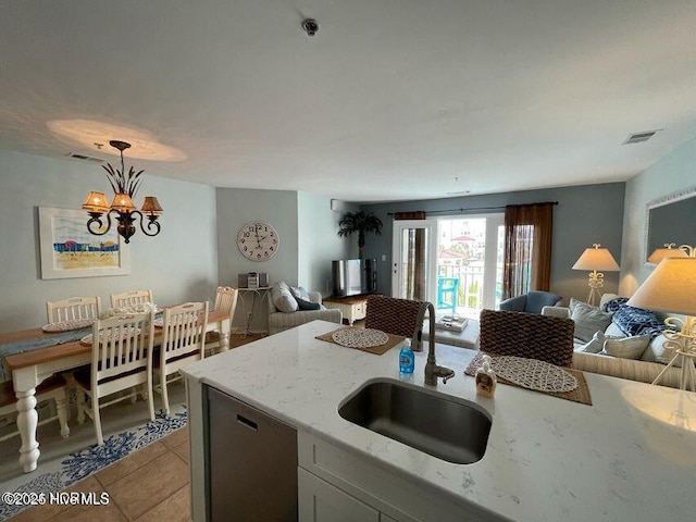790 New River Inlet Rd Unit 208B, North Topsail Beach, NC 28460 - kitchen with stainless steel dishwasher, open floor plan, light stone countertops, and a sink
