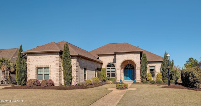 8800 Maple Ash Trl NE, Leland, NC 28451 - french country inspired facade featuring brick siding and a shingled roof