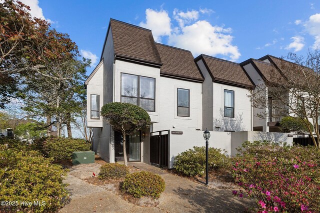 125 Hatteras Ct, Morehead City, NC 28557 - view of property exterior with a shingled roof and stucco siding
