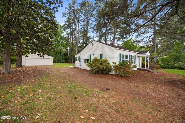 705 W Main St, Conway, NC 27820 - view of side of home with an outdoor structure, a garage, and a yard