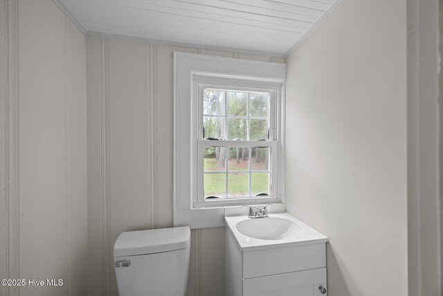 705 W Main St, Conway, NC 27820 - bathroom with toilet, vanity, ornamental molding, and a decorative wall