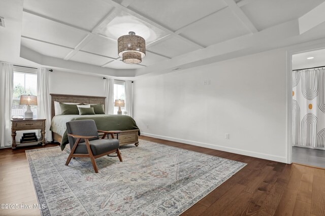 bedroom featuring coffered ceiling, baseboards, visible vents, and hardwood / wood-style flooring