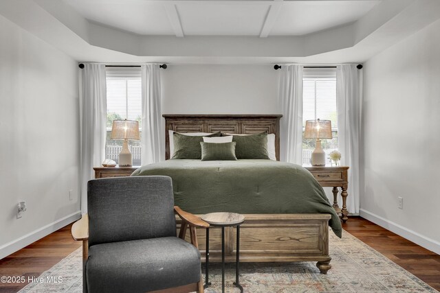 bedroom with baseboards and wood finished floors
