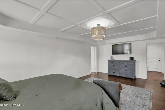 bedroom with an inviting chandelier, baseboards, wood finished floors, and coffered ceiling