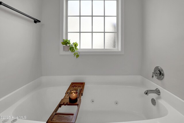 bathroom with a tub with jets