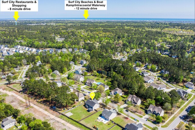 birds eye view of property with a residential view and a forest view