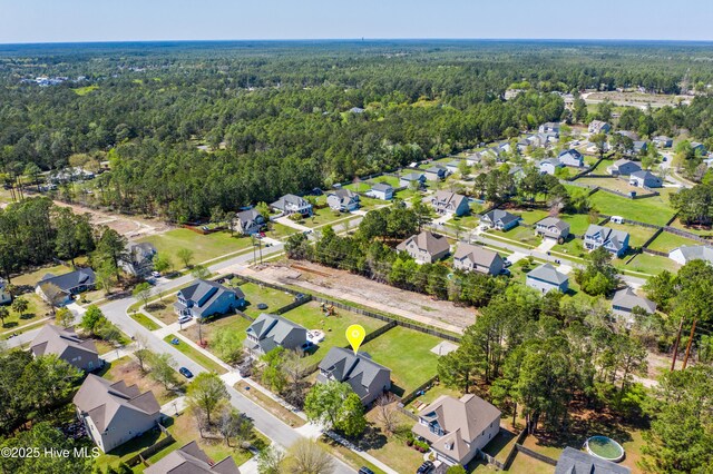 birds eye view of property with a residential view and a forest view