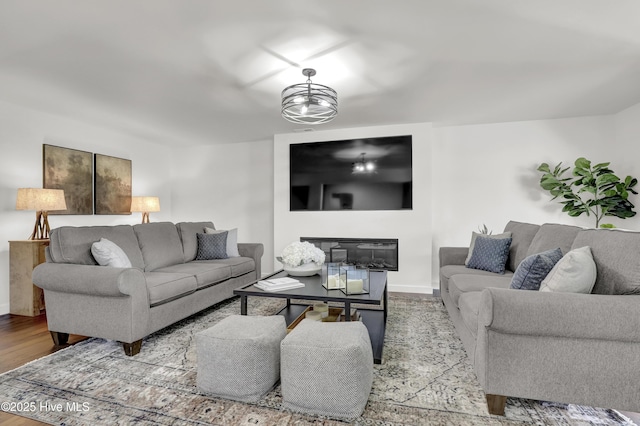 living room featuring wood finished floors and baseboards