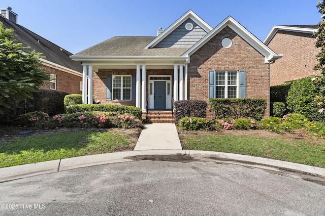 1502 Crows Landing Cir, Wilmington, NC 28403 - view of front of property featuring brick siding, covered porch, and a shingled roof