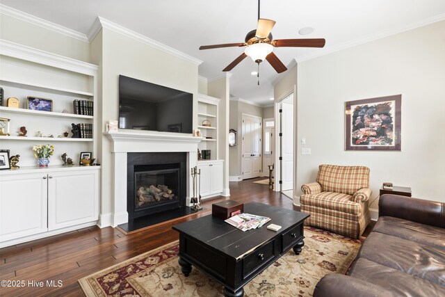 1502 Crows Landing Cir, Wilmington, NC 28403 - living room featuring ceiling fan, dark wood-style flooring, crown molding, a glass covered fireplace, and baseboards