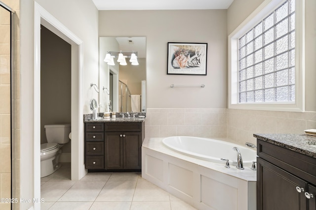 1502 Crows Landing Cir, Wilmington, NC 28403 - bathroom with tile patterned flooring, a shower stall, two vanities, and a garden tub
