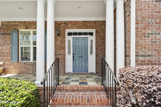 1502 Crows Landing Cir, Wilmington, NC 28403 - view of exterior entry with a porch and brick siding