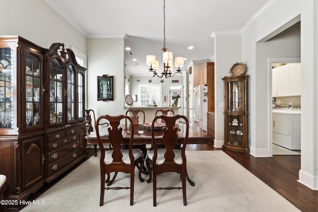 1502 Crows Landing Cir, Wilmington, NC 28403 - dining area with a chandelier, wood finished floors, washer and dryer, crown molding, and recessed lighting