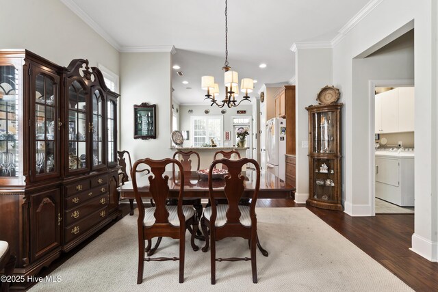 1502 Crows Landing Cir, Wilmington, NC 28403 - dining area with a chandelier, wood finished floors, washer and dryer, crown molding, and recessed lighting