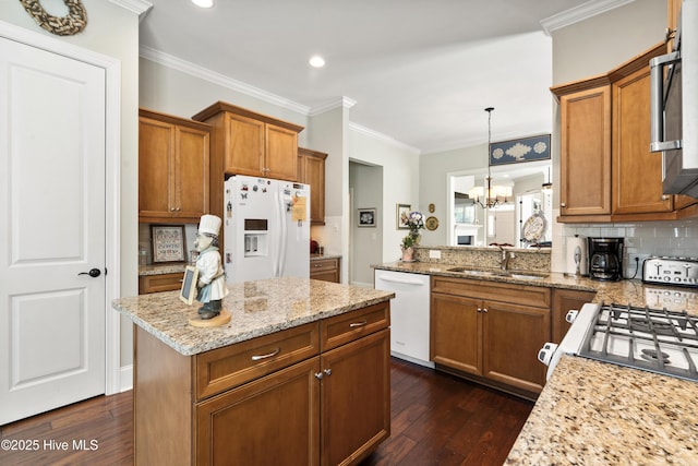 1502 Crows Landing Cir, Wilmington, NC 28403 - kitchen featuring white appliances, a sink, brown cabinets, dark wood-style flooring, and ornamental molding