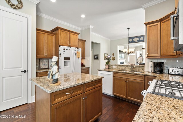 1502 Crows Landing Cir, Wilmington, NC 28403 - kitchen featuring white appliances, a sink, brown cabinets, dark wood-style flooring, and ornamental molding