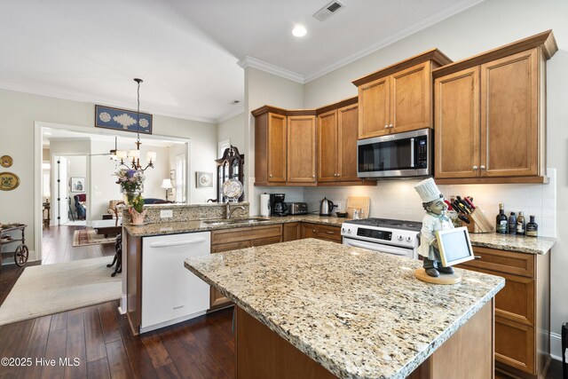 1502 Crows Landing Cir, Wilmington, NC 28403 - kitchen featuring white appliances, a sink, brown cabinetry, light stone counters, and ornamental molding