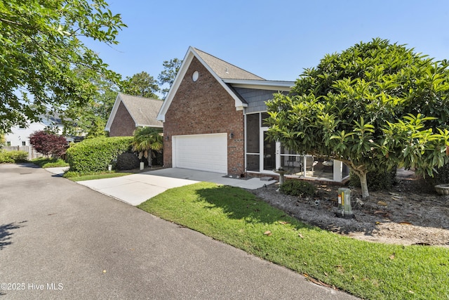 1502 Crows Landing Cir, Wilmington, NC 28403 - view of front of home with concrete driveway, brick siding, and a front lawn
