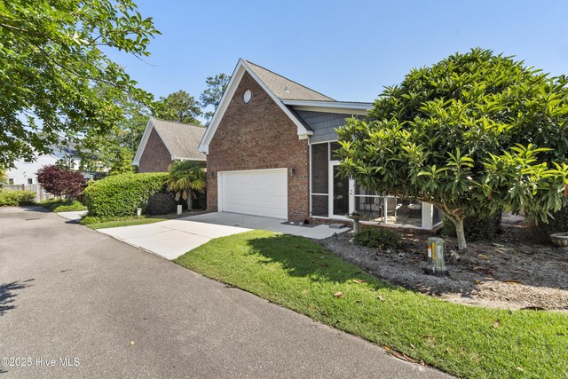 1502 Crows Landing Cir, Wilmington, NC 28403 - view of front of home with concrete driveway, brick siding, and a front lawn