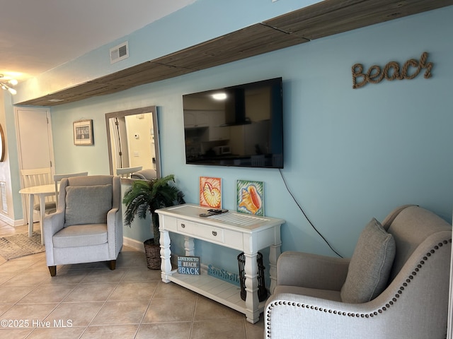 sitting room featuring tile patterned floors, baseboards, and visible vents