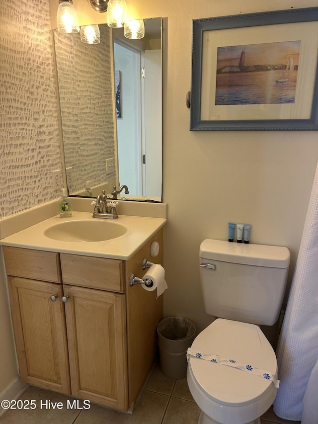 bathroom with vanity, tile patterned flooring, and toilet