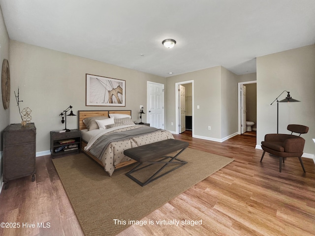 bedroom with wood finished floors and baseboards