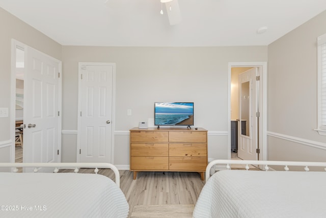 bedroom with light wood-style flooring and a ceiling fan
