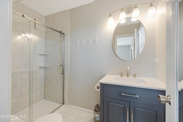bathroom with baseboards, a shower stall, marble finish floor, and vanity