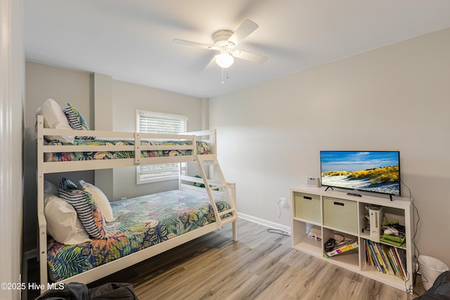bedroom featuring baseboards, a ceiling fan, and wood finished floors