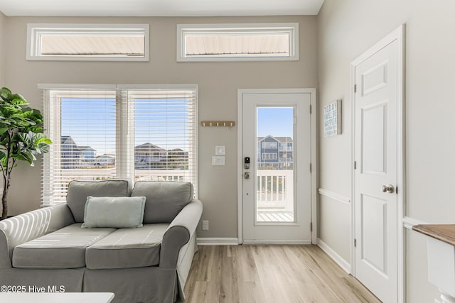 entryway featuring plenty of natural light, light wood-style flooring, and baseboards