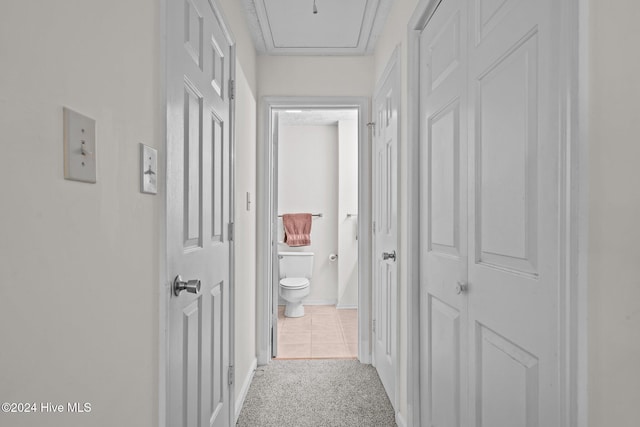 hallway with tile patterned floors and carpet floors