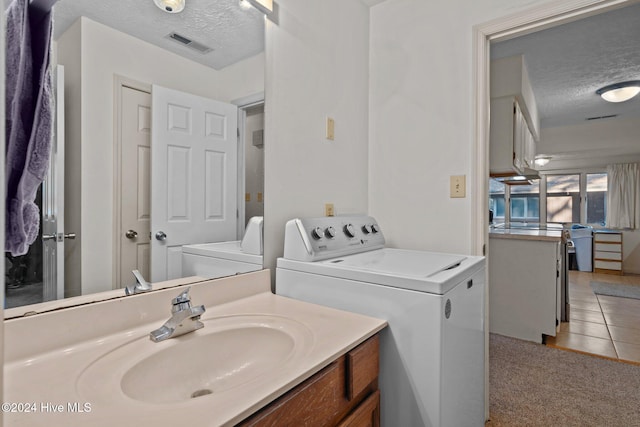 bathroom featuring a textured ceiling, visible vents, tile patterned flooring, and vanity