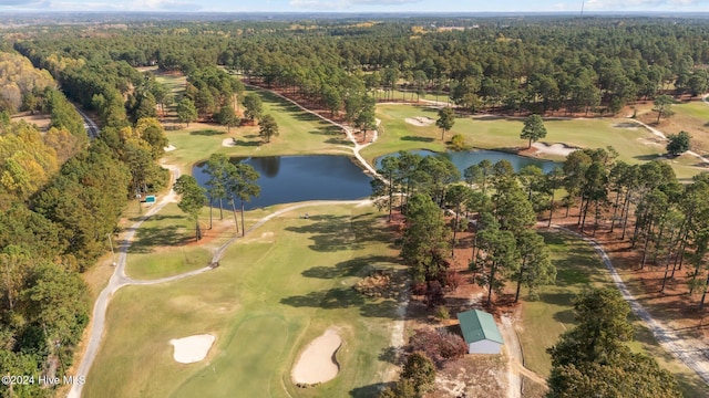 bird's eye view featuring view of golf course, a water view, and a view of trees