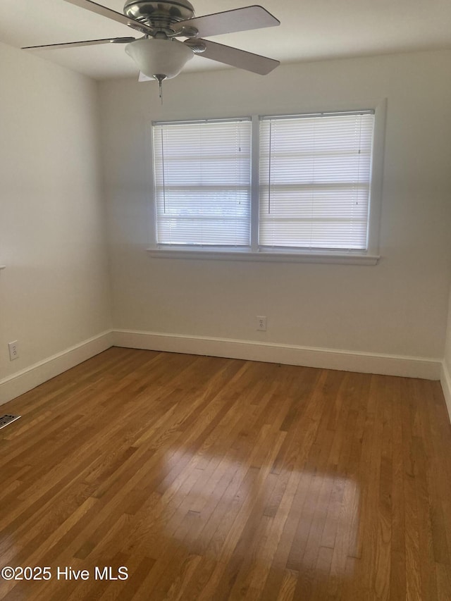 empty room with wood finished floors and baseboards