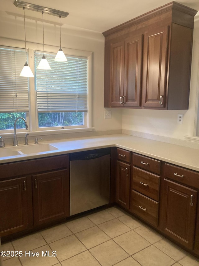 kitchen featuring stainless steel appliances, light countertops, light tile patterned floors, and dark brown cabinetry