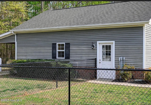 1714 Pine St, Elizabeth City, NC 27909 - doorway to property featuring a lawn, a shingled roof, and fence