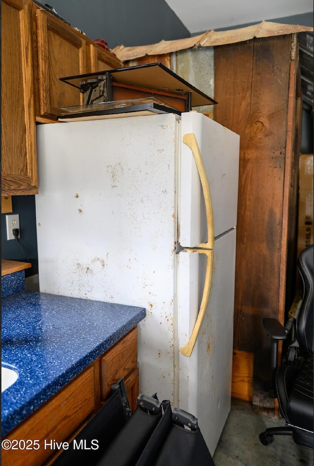 1714 Pine St, Elizabeth City, NC 27909 - interior space with concrete floors, brown cabinetry, and freestanding refrigerator