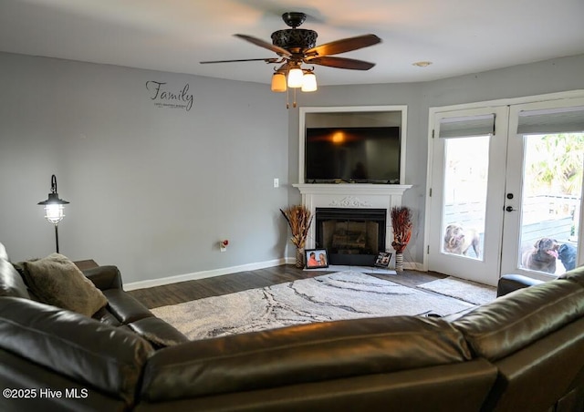 1714 Pine St, Elizabeth City, NC 27909 - living room featuring wood finished floors, baseboards, a fireplace, and ceiling fan