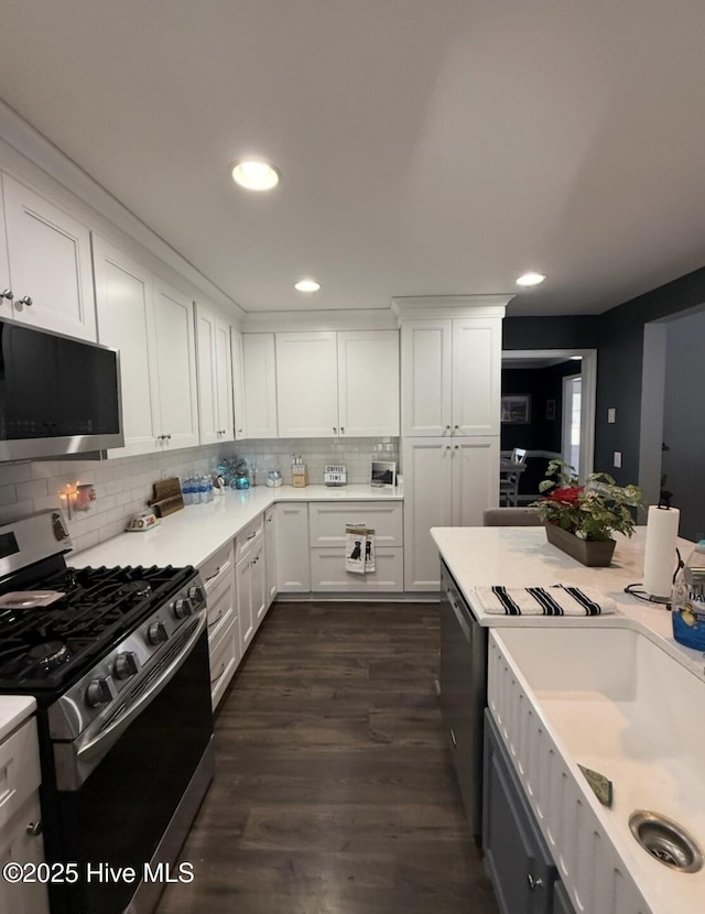 1714 Pine St, Elizabeth City, NC 27909 - kitchen featuring light countertops, tasteful backsplash, white cabinets, and appliances with stainless steel finishes