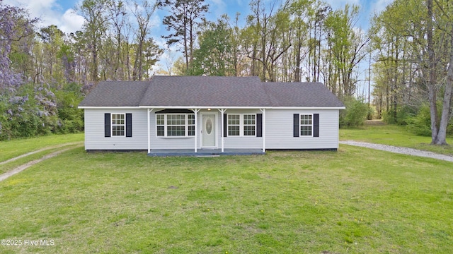 view of front facade featuring roof with shingles and a front lawn