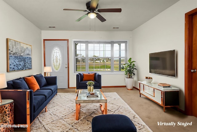 living area featuring light carpet, ceiling fan, baseboards, and visible vents