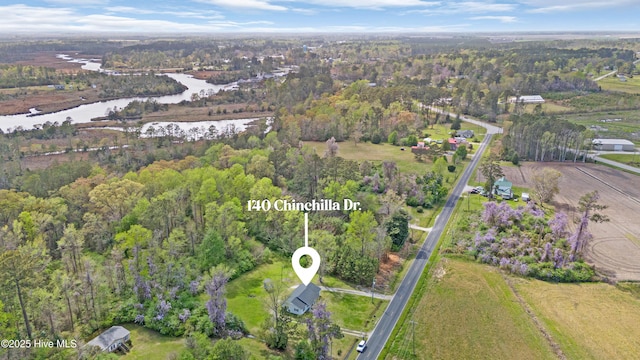 birds eye view of property with a forest view and a water view