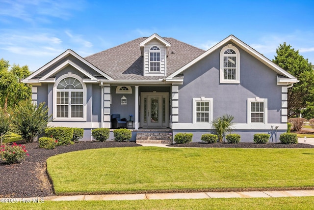 1096 Rutledge Ct NW, Calabash, NC 28467 - view of front of house featuring a front lawn, stucco siding, roof with shingles, and covered porch