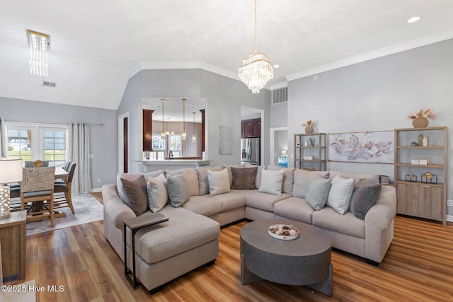 1096 Rutledge Ct NW, Calabash, NC 28467 - living area featuring a chandelier, wood finished floors, vaulted ceiling, and baseboards