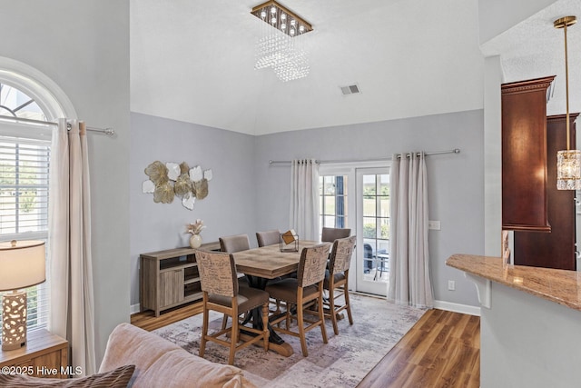 1096 Rutledge Ct NW, Calabash, NC 28467 - dining space with light wood finished floors, a chandelier, lofted ceiling, and baseboards