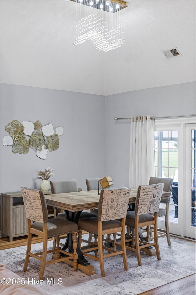 1096 Rutledge Ct NW, Calabash, NC 28467 - dining area featuring lofted ceiling, a chandelier, and light wood-type flooring